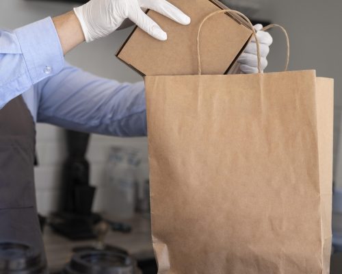 man-with-apron-preparing-food-takeaway